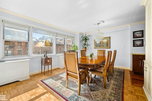 dining area with baseboards, an inviting chandelier, and crown molding