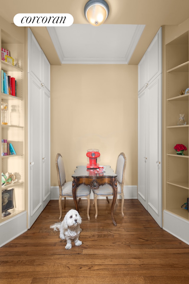 dining area featuring baseboards, wood finished floors, and ornamental molding