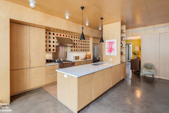 kitchen with stainless steel stove, exhaust hood, concrete floors, and light brown cabinetry