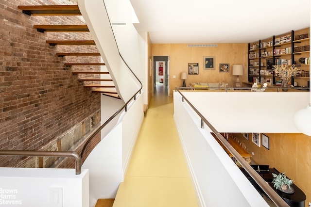 interior space with visible vents and brick wall