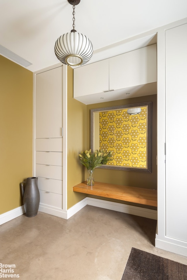 interior space featuring baseboards and finished concrete floors