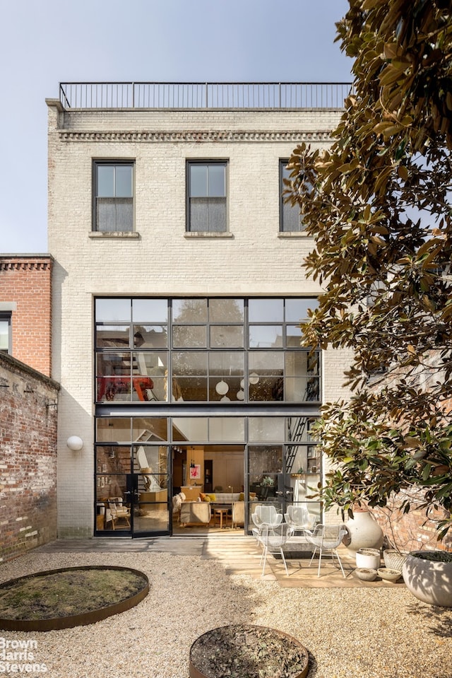 back of property featuring brick siding