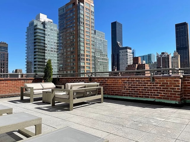 view of patio / terrace featuring a view of city and an outdoor hangout area