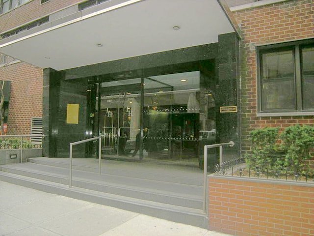 property entrance with brick siding