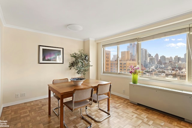 dining area with a skyline view, baseboards, and crown molding