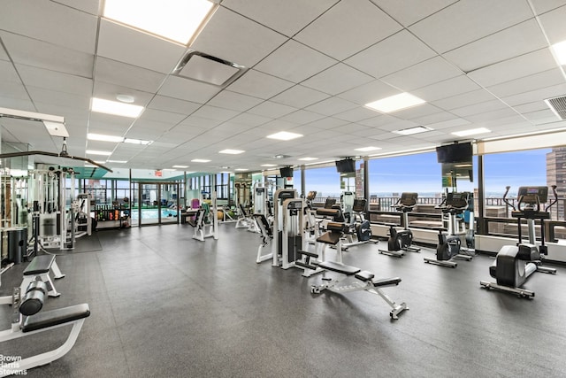 20 W 64th St Unit 12P, New York City, NY 10023 - gym with healthy amount of natural light and a paneled ceiling