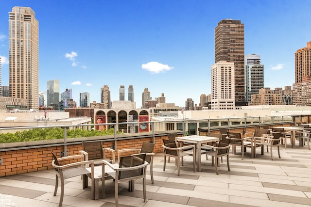 view of patio / terrace with a city view and outdoor dining space