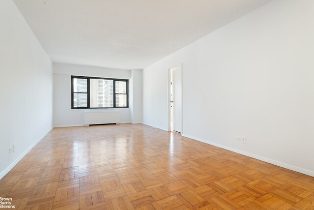 20 W 64th St Unit 12P, New York City, NY 10023 - empty room with radiator and baseboards