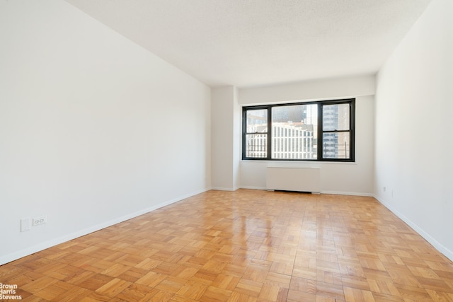 20 W 64th St Unit 12P, New York City, NY 10023 - empty room with radiator heating unit and baseboards