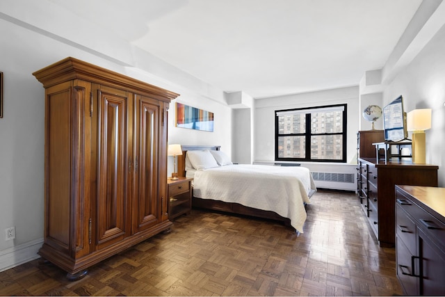 bedroom featuring radiator and baseboards