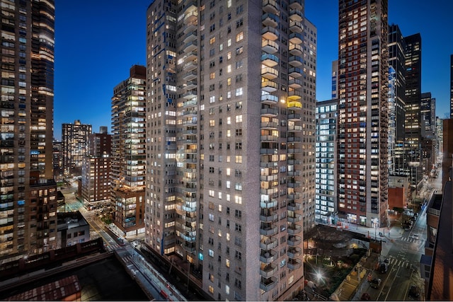 property at night with a view of city lights