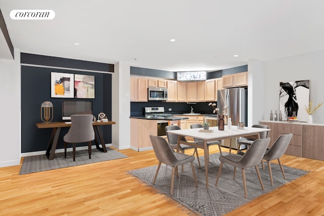 dining space with light wood finished floors, baseboards, and recessed lighting