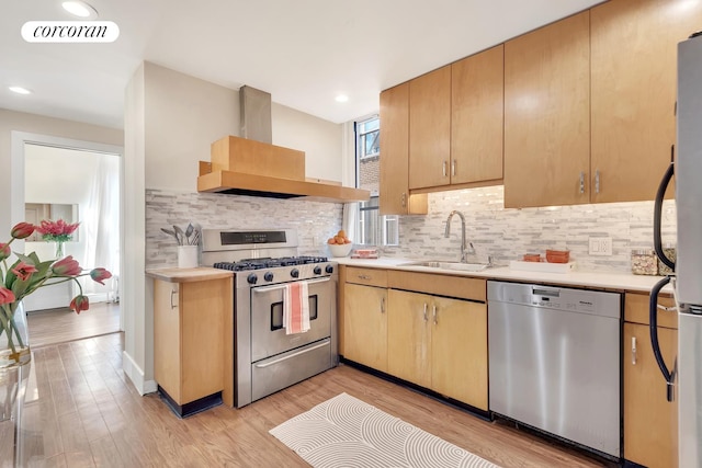 kitchen featuring visible vents, island exhaust hood, a sink, stainless steel appliances, and light countertops