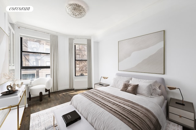 bedroom featuring wood finished floors and visible vents