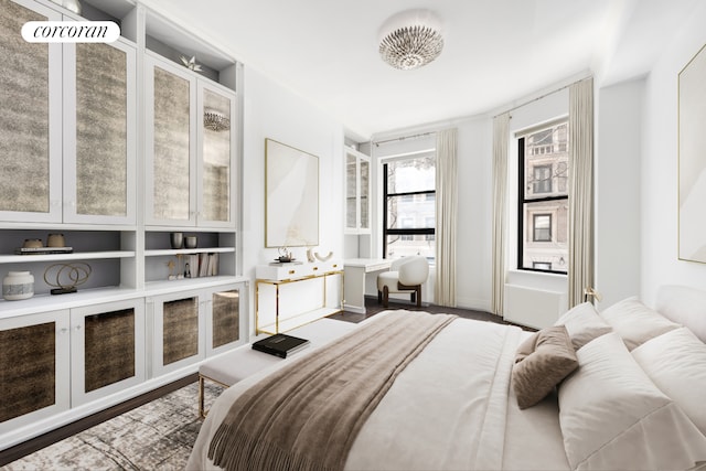 bedroom featuring baseboards and wood finished floors