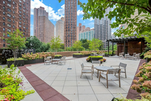 view of patio / terrace with a pergola and a city view