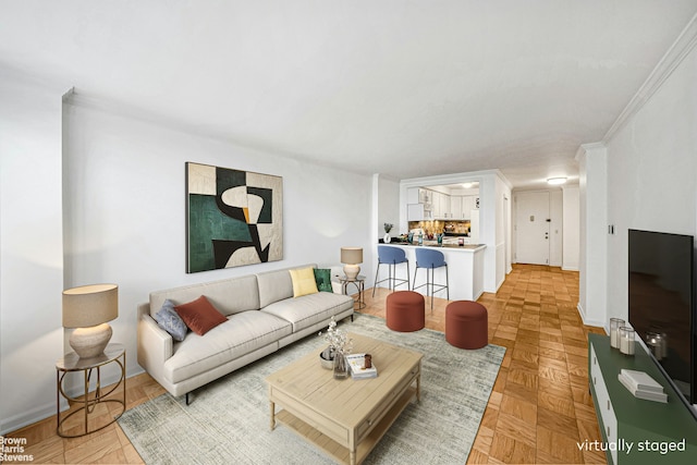 living room with baseboards and ornamental molding