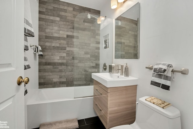 bathroom with shower / bath combination, vanity, toilet, and tile walls