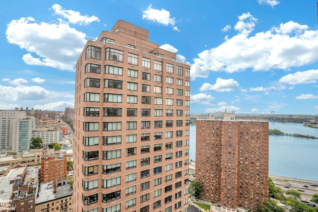 view of building exterior featuring a view of city and a water view