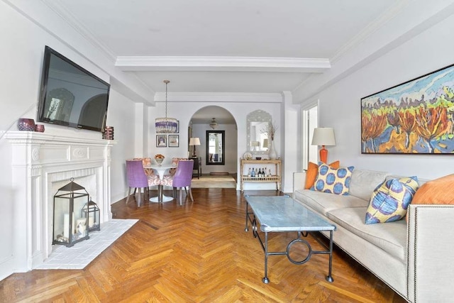 living area with beamed ceiling, arched walkways, and crown molding