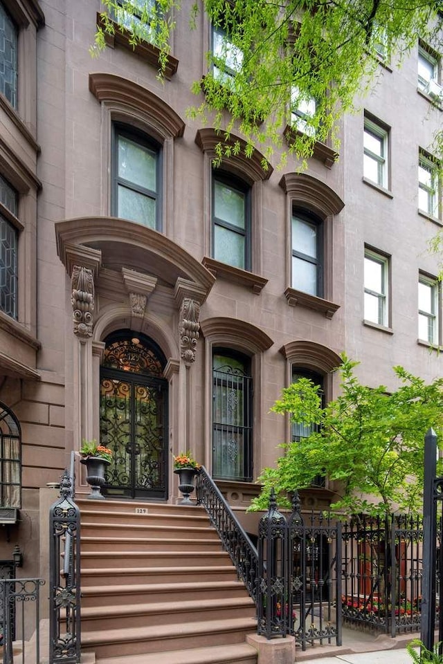 doorway to property featuring french doors and fence