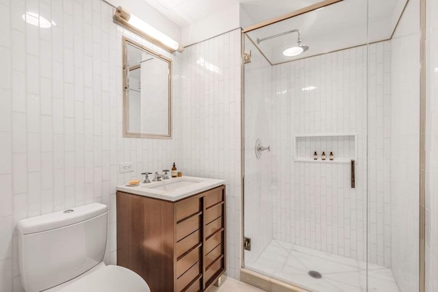 full bathroom featuring vanity, toilet, tile walls, and a shower stall