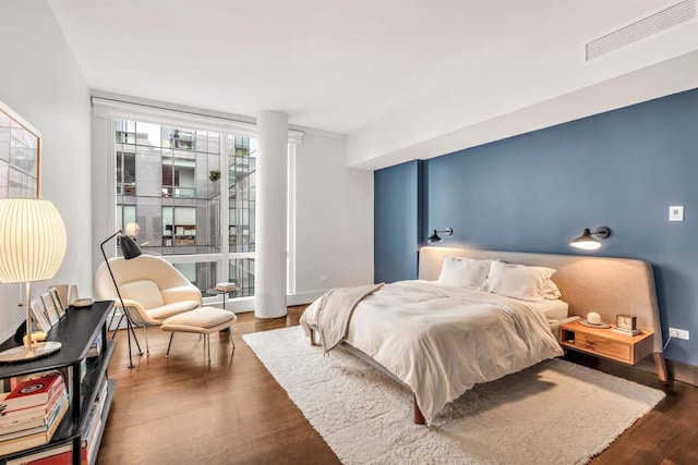 bedroom with visible vents and wood finished floors