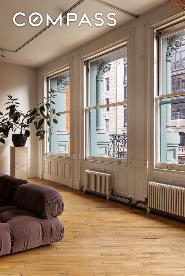 515 Broadway Unit 4B, New York City, NY 10012 - doorway featuring radiator heating unit and hardwood / wood-style flooring