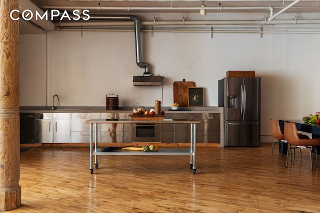 515 Broadway Unit 4B, New York City, NY 10012 - kitchen featuring stainless steel refrigerator with ice dispenser, wood finished floors, a sink, and dishwasher