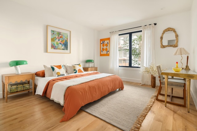 bedroom with baseboards and light wood-style floors