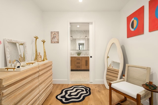 bathroom featuring recessed lighting, vanity, baseboards, and wood finished floors