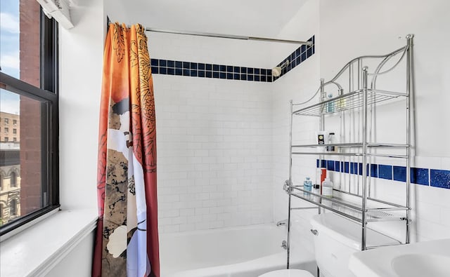 bathroom with toilet and shower / bathtub combination with curtain