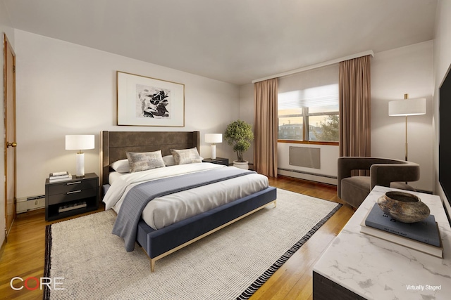 bedroom featuring wood finished floors and a baseboard radiator