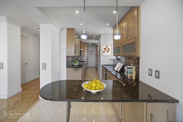 255 E 49th St Unit 31Abf, New York City, NY 10022 - kitchen with a sink, decorative backsplash, dark stone counters, glass insert cabinets, and baseboards