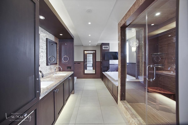 255 E 49th St Unit 31Abf, New York City, NY 10022 - full bath featuring tile patterned floors, double vanity, a bath, recessed lighting, and a stall shower