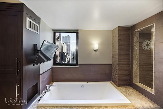 full bathroom featuring a bath and visible vents