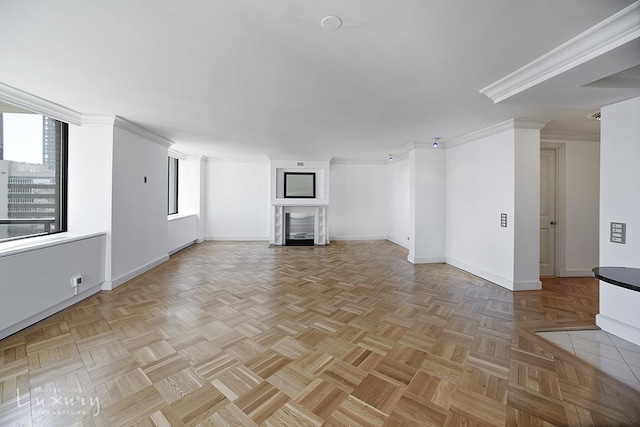 unfurnished living room with baseboards, a fireplace, and crown molding