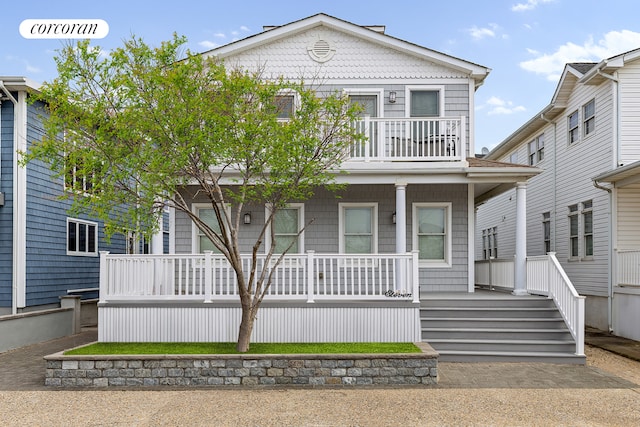 view of front of house with covered porch and a balcony