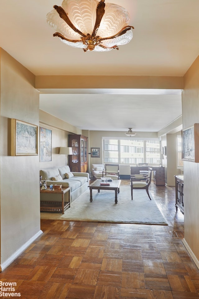 living area featuring baseboards