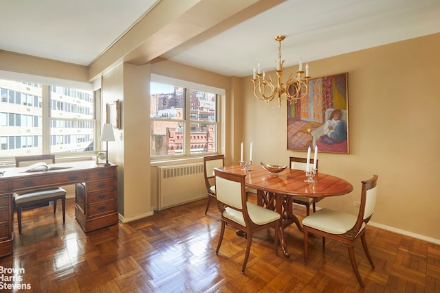 dining space with a chandelier, radiator heating unit, and baseboards