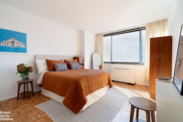 bedroom with radiator and baseboards