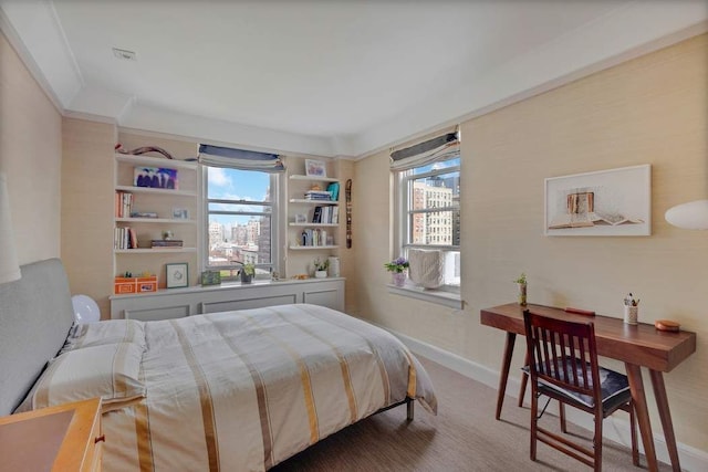 bedroom featuring multiple windows, baseboards, and carpet