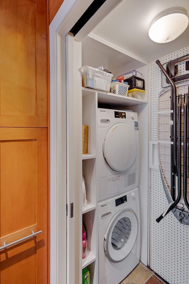 laundry room featuring stacked washer and dryer