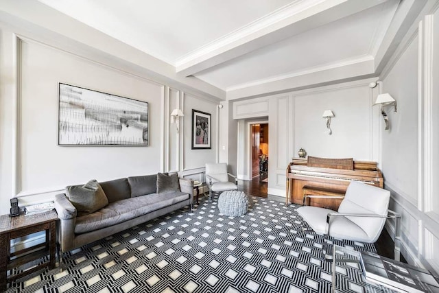 living room featuring beam ceiling, wood finished floors, and ornamental molding