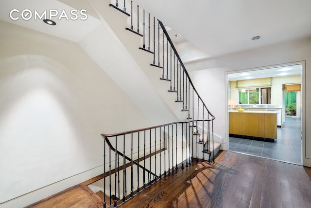 stairway featuring recessed lighting and hardwood / wood-style floors