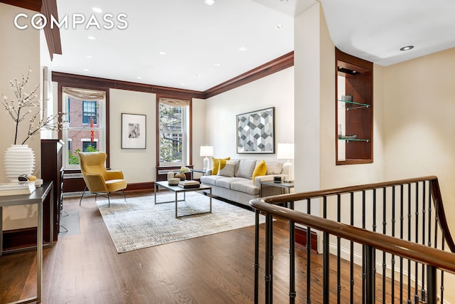 living area featuring baseboards, recessed lighting, wood finished floors, and ornamental molding