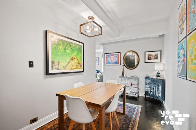 dining space with baseboards and an inviting chandelier