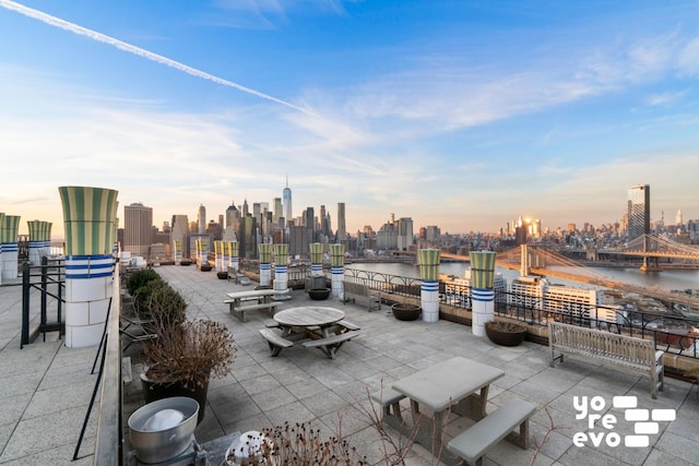 view of patio with a water view and a city view