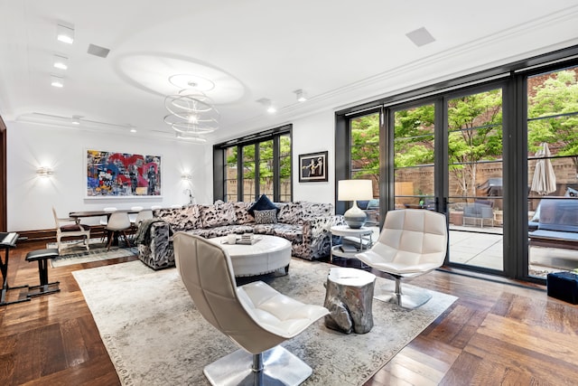 living area featuring crown molding and a chandelier