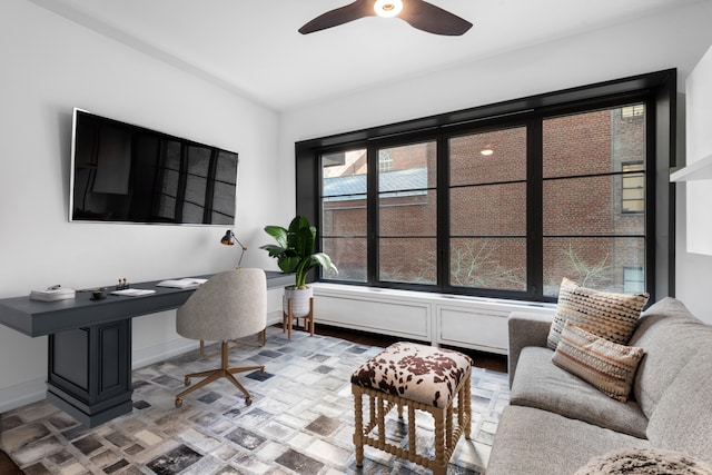 home office featuring ceiling fan and baseboards